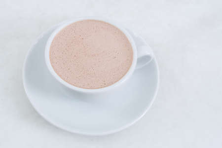 Hot chocolate in a white cup on tableの写真素材