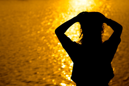 Silhouette of Woman's at Sunsetの写真素材