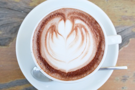 Hot chocolate in a white cup on tableの写真素材