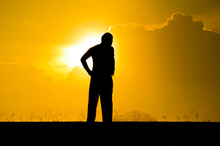 Blurred silhouette a man exercise during sunsetの写真素材