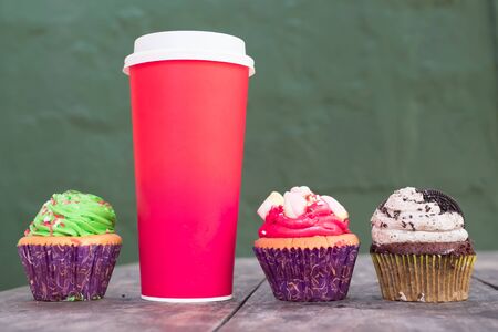 red cup coffee and Cupcakes on the tableの写真素材