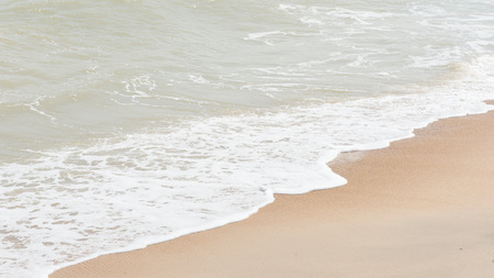 green ocean wave with white sand for backgroundの写真素材