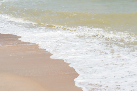 green ocean wave with white sand for backgroundの写真素材