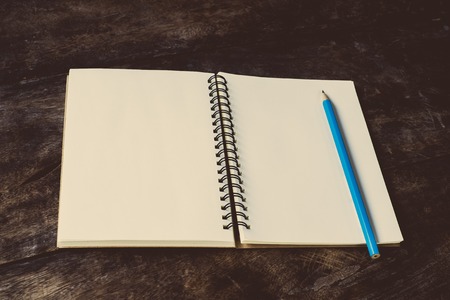 still life with notebook and pencil on table - vintage filterの写真素材