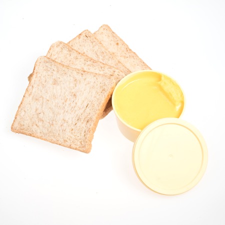 Slice of white bread with butter isolated on white