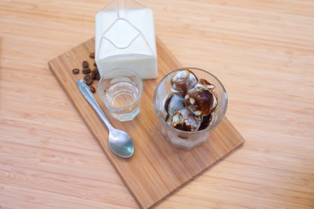Iced coffee latte homemade making from ice cubes coffee frozen served with milkの写真素材