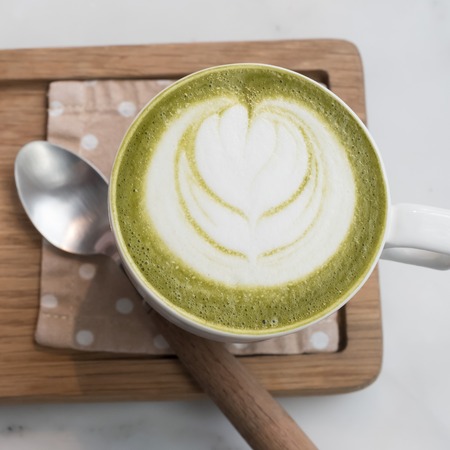 green tea latte on wood background