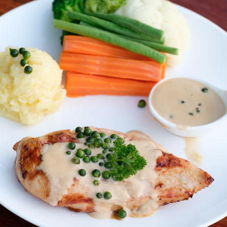Grilled chicken steak  on the tableの写真素材
