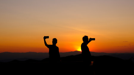 silhouette two people selfie  a pictureの写真素材
