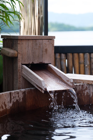 Japanese open air Bath (focus on the flowing water)の写真素材
