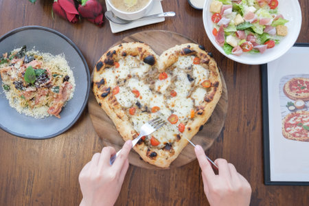 ilttle girl eating pizza in the shopの写真素材