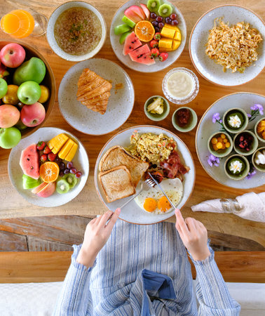 woman eating healthy breakfast on the tableの写真素材