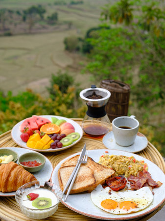 American breakfast with eggs, bread,bacon,milk, coffee and orange juiceの写真素材