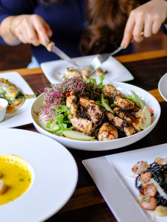 young women eating healthy food in restaurantsの写真素材