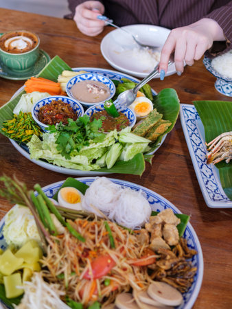 young women eating thai food in the coffee shopの写真素材
