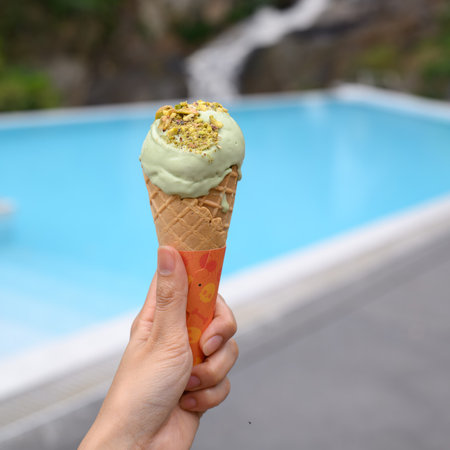 ice cream on hand with water fall background