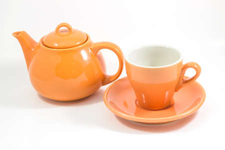 Orange teapot and orange cup isolated on white background, stock photoの写真素材