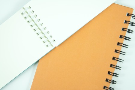 orange and white notebook with spiral