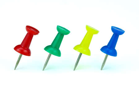 Colorful push pins arranged on white background の写真素材