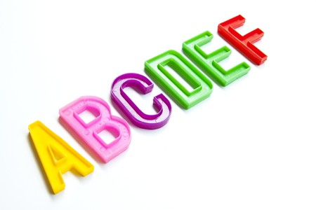 Colorful plastic alphabet, six letters A-F, isolated on whiteの写真素材