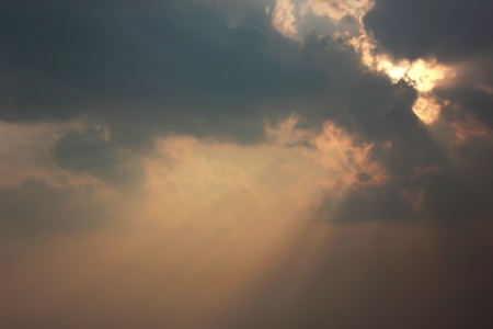 Rays of light shining through dark cloudsの写真素材