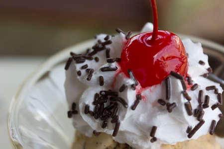 The sundae is a sweet ice cream dessert  It typically consists of one or more scoops of ice cream topped with sauce or syrup, and in some cases other toppings including sprinkles, whipped cream, maraschino cherries, or other fruits  e g , bananas and pineの写真素材