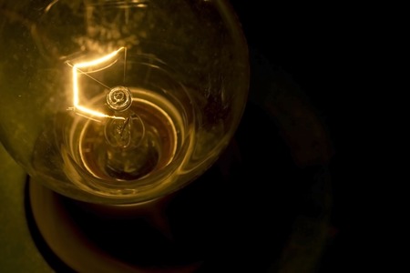 Dusty Incandescent tungsten light bulb on a dark background 