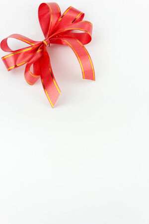 Red ribbon bow on white backgroundの写真素材
