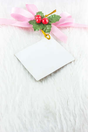 Christmas and New Year gift card with ribbon and satin bow の写真素材