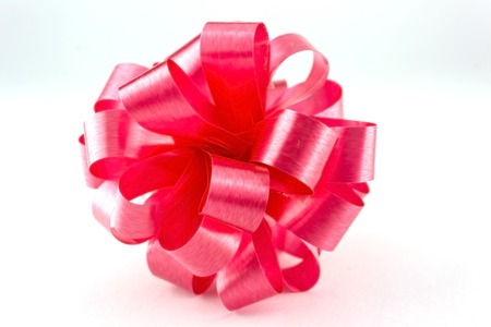 Red ribbon bow on white の写真素材