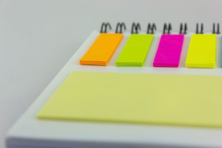 Note pads on notebook on isolated white background.の写真素材