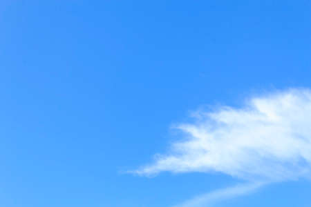 Blue sky with tiny clouds.の写真素材