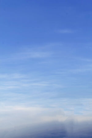 Blue sky with tiny clouds.の写真素材