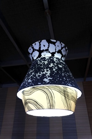 Modern lamp hanging on the ceiling in the room.の写真素材