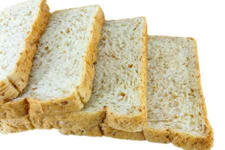 Closeup image of cut of loaf bread on white against white background.