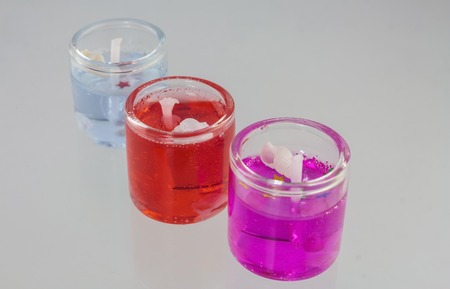 Beautiful colorful sweet scent candles on white background.の写真素材