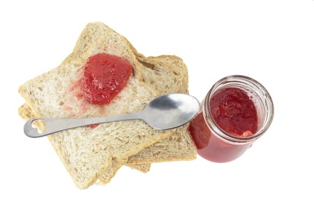 Closeup pile of sliced bread with strawberry jam on white background.の写真素材