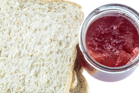 Closeup pile of sliced bread with strawberry jam on white background.の写真素材
