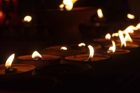 Closeup Group of burning candles in thai style.の写真素材