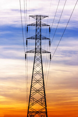 High voltage power lines with electricity pylons at twilight.の写真素材