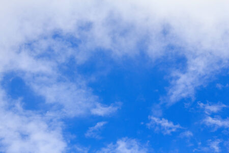 Blue sky background with tiny white cloud.の写真素材