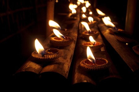 Closeup Group of burning candles in thai style.の写真素材