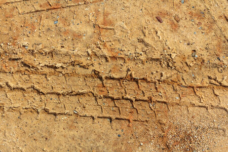 Closeup tire track on the ground. Tire truck print on the groundの写真素材