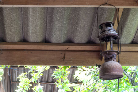 Rustic lantern on wood panel wall under the roof.の写真素材