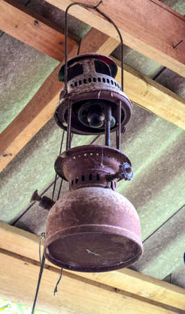 Rustic lantern on wood panel wall under the roof.の写真素材