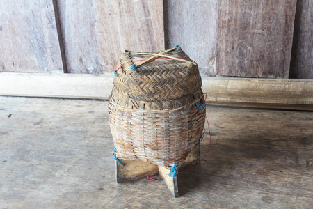 Thai bamboo sticky rice. Thai bamboo sticky rice container on wooden background.の写真素材