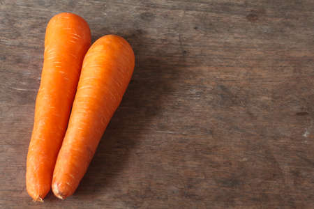Carrots. Orange carrots on a wooden background.の写真素材