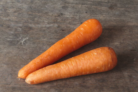 Carrots. Orange carrots on a wooden background.の写真素材