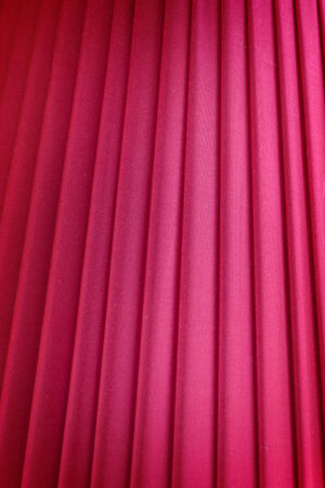 Red background, closeup of red silk textured cloth background.の写真素材