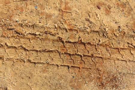 Closeup tire track on the ground. Tire truck print on the groundの写真素材